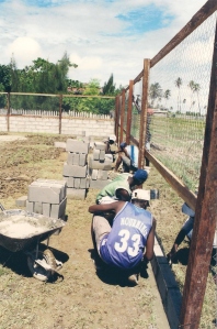 56r students build wall to fence sports area